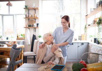 Aged pensioner feeling thankful to her pleasant caregiver