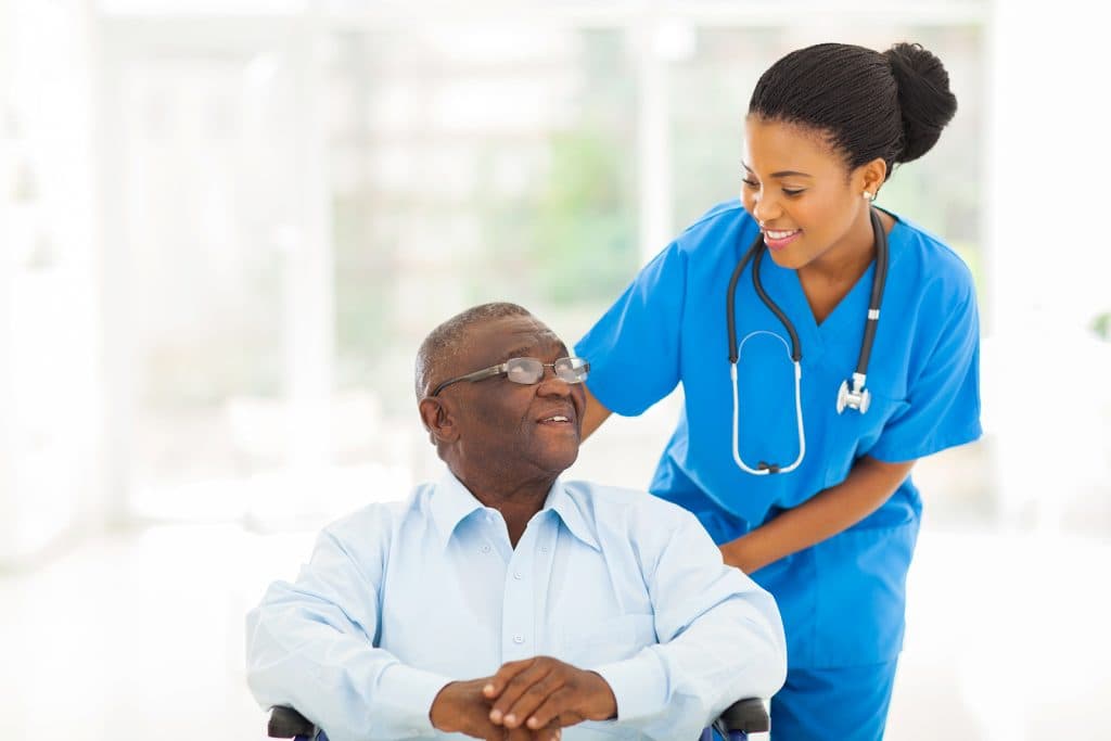 Compassionate carer supporting an elderly person during the night